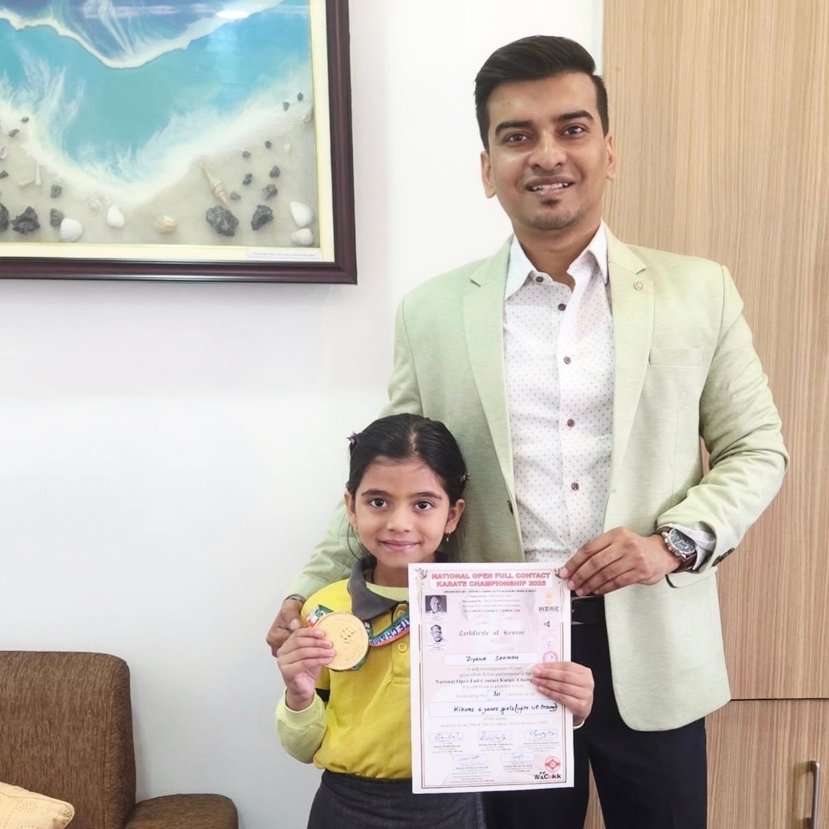 Centre Head with a student holding her National Karate Championship gold medal and certificate